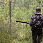 hunter shooting on the walk in forest